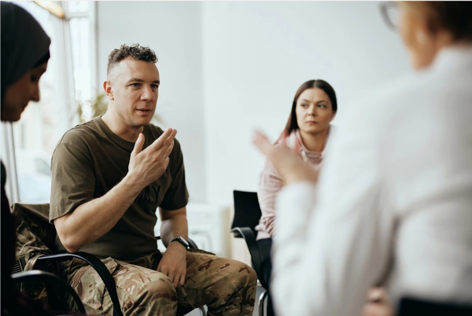 a veteran sitting and sharing with a group of people