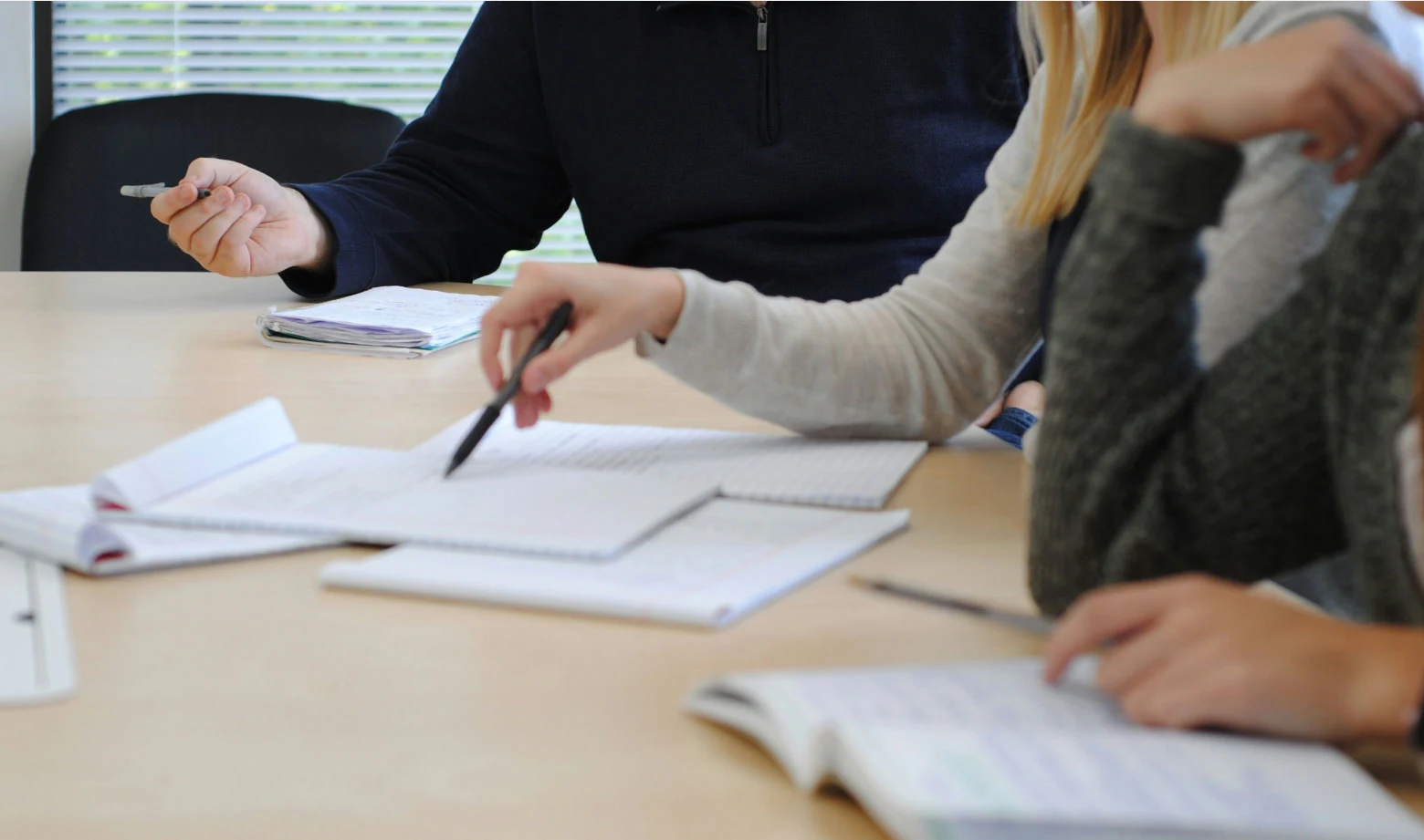 a group of people sitting in a business meeting