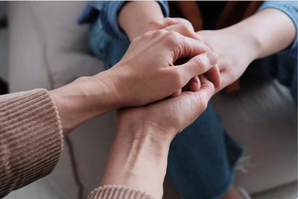 2 sets of hands holding each other