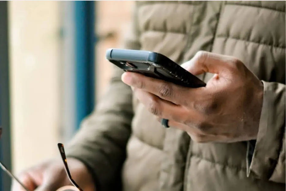 a person holding their mobile phone
