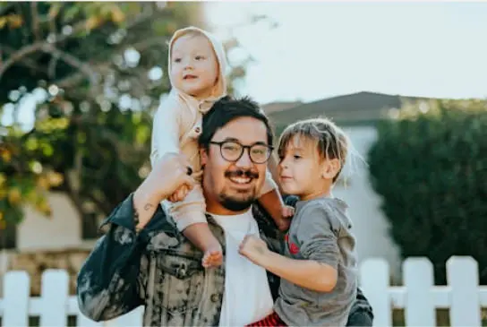 a picture of a dad with his two daugthers