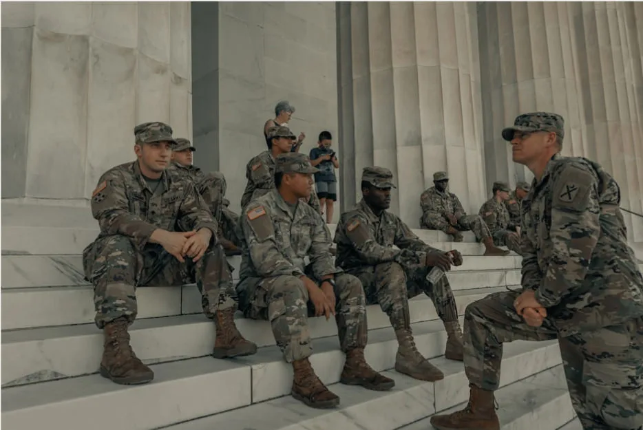 Military men sitting on a building steps