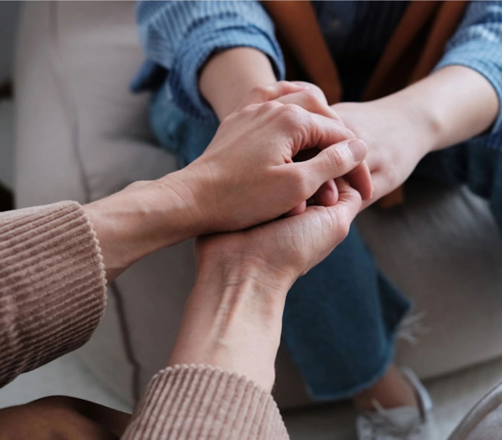 2 sets of hands holding each other