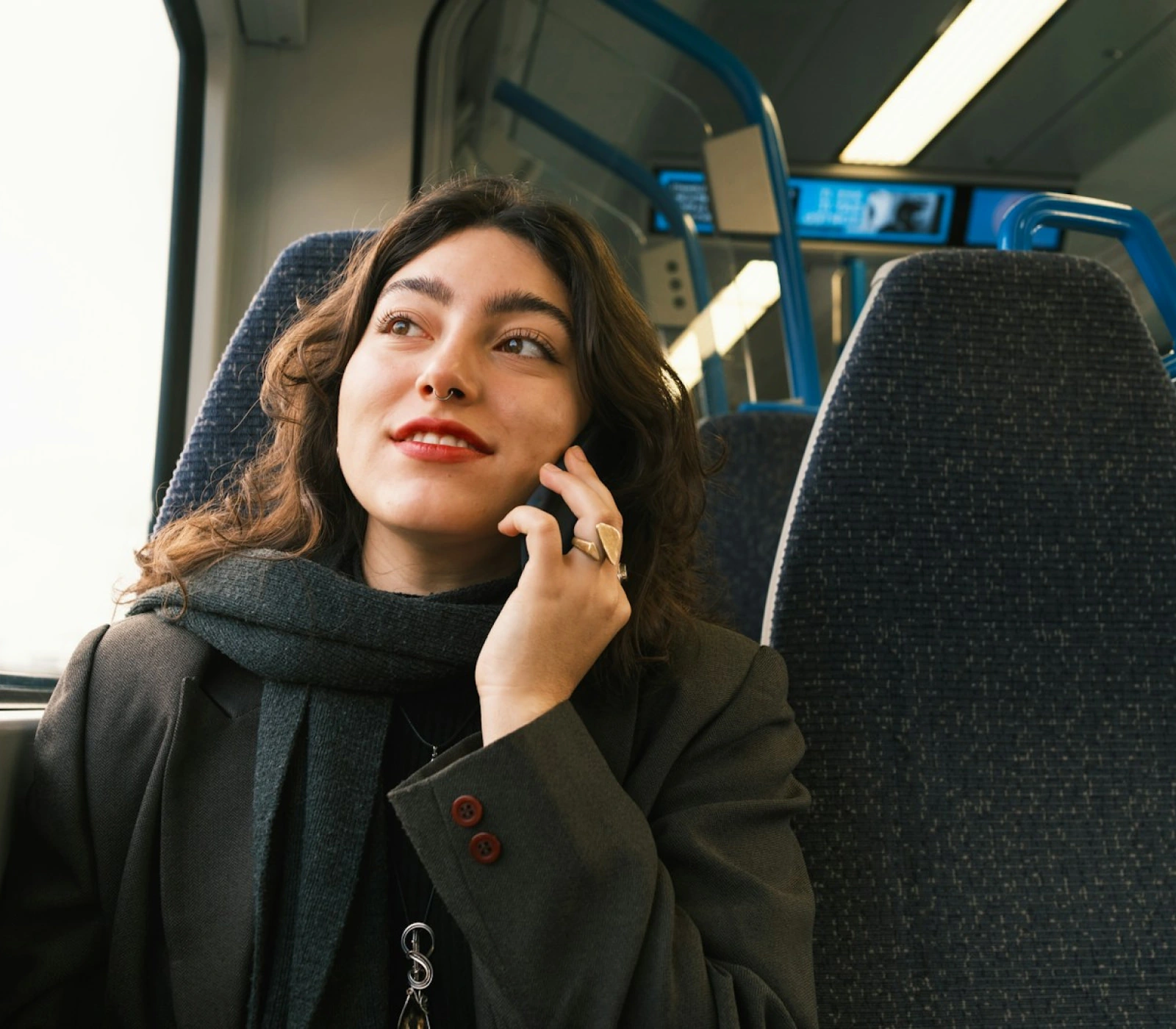 a woman in transit talking on the phone