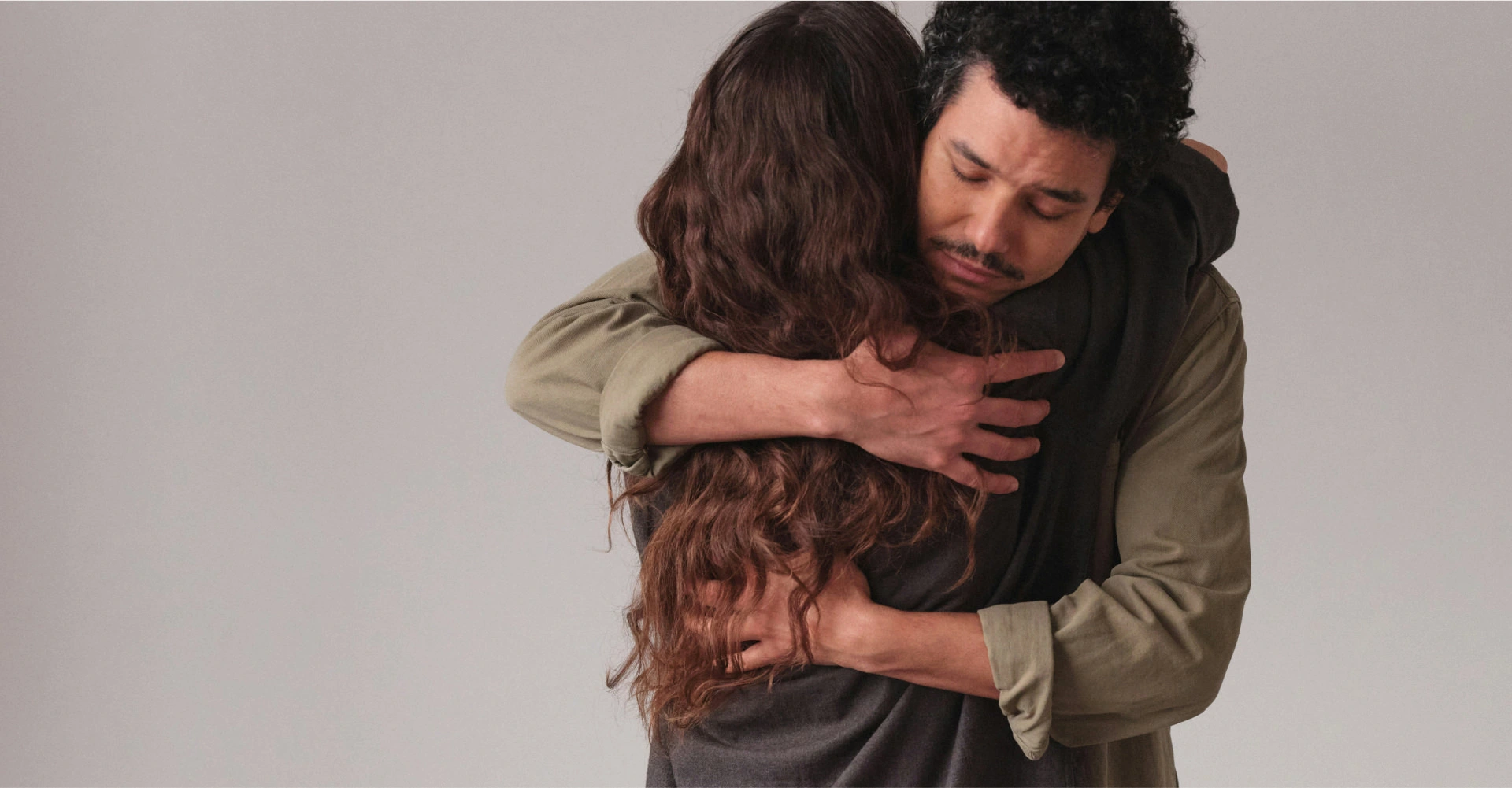 a man and woman hugging each other